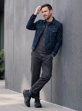 Versablast 4 Wide – Casual weekend: Dark indigo athletic-fit jeans cuffed at the ankle, a heathered grey quarter-zip fleece pullover, and a minimalist black baseball cap.