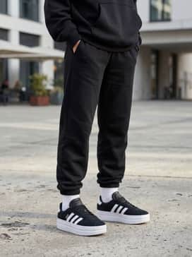 Black high-waisted leggings worn with white crew socks pulled over the hem, topped with an oversized neon-colored hoodie for a modern athleisure aesthetic.