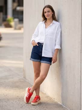 Vl Court Bold Shoes – Dark indigo denim shorts with a wide-cut white linen button-down shirt and gold dainty jewelry to let the bold red and pink tones of the sneakers stand out.