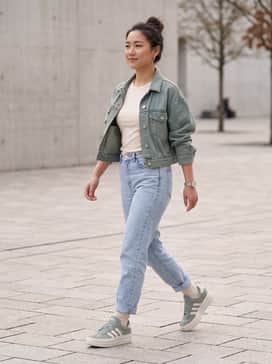 High-waisted light wash mom jeans, a tucked-in cream baby tee, and a cropped denim jacket.