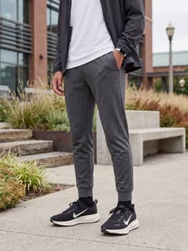 A relaxed weekend outfit with slim-fit grey chinos, a white cotton t-shirt, and a classic denim jacket to transition from play to lunch.