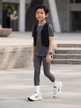 Vomero 18 – A sleek pair of black moisture-wicking leggings paired with a charcoal grey performance t-shirt and a matching lightweight running vest.