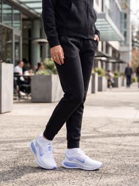 Vomero 18 – Black tech-fleece joggers and a matching zip-up hoodie for an urban, sporty streetwear vibe.