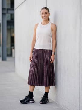 Warm-weather running: Match with metallic-accented running shorts in a dark plum shade and a breathable mesh singlet in off-white.