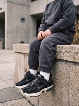 A miniature tracksuit in black or navy to create a sleek, coordinated athletic aesthetic.