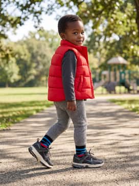 Comfy leggings paired with a bright puffer vest for a functional and fashionable outdoor ensemble.
