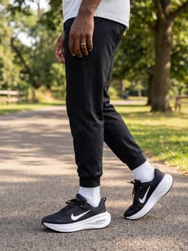Slim-fit black joggers paired with a heather grey zip-up hoodie over a minimalist white crewneck tee for a comfortable yet stylish commute.