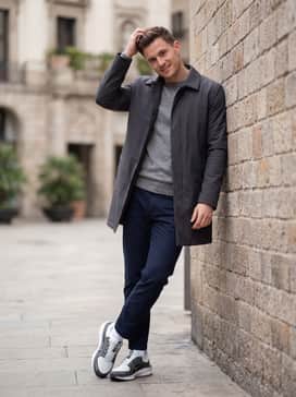 Winflo 11 Goretex – A casual commuter outfit consisting of slim-fit navy chinos, a heather grey merino wool sweater, and a minimalist waterproof mac coat.