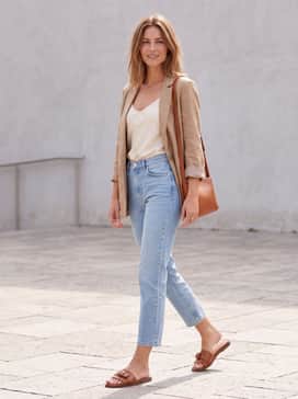 Womens Goto Emalia Slide Bow Sandals – Light-wash cropped jeans combined with a silk cream-colored camisole and a tan leather crossbody bag for a polished weekend errand run.