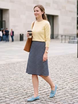 Womens Grand Ambition Alette Buckle Loafers – A navy and white striped midi skirt combined with a tucked-in soft yellow cashmere sweater to create a bright, preppy aesthetic.