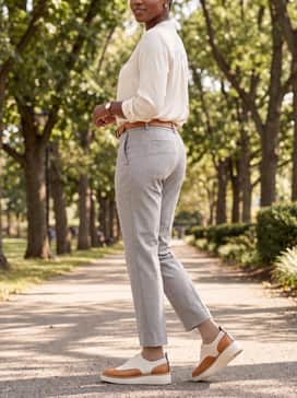 Womens Riginalgrand Platform Wingtip Oxfords – Ankle-length charcoal grey slacks and a light blue pinstripe shirt, accessorized with a tan leather belt to match the shoe's accents.
