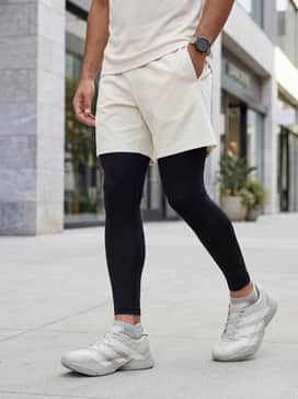 Y3 Adios Pro 4 Shoes – An effortless athleisure look with matte black compression tights, a cream-colored oversized hoodie, and a sleek sports watch.