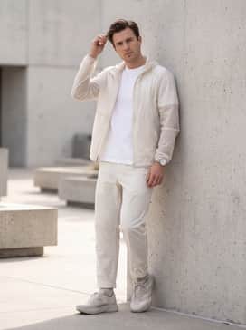A minimalist tech-wear ensemble with light grey nylon utility pants, a white boxy-fit tee, and a matching translucent windbreaker.