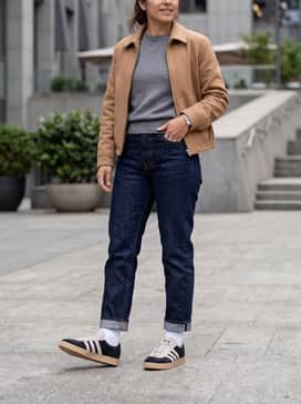 Dark indigo straight-leg denim paired with a premium grey cashmere turtleneck and a camel-colored Harrington jacket to complement the gum sole.