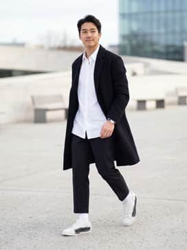 Y3 Nizzastar Lo Shoes – Black cropped trousers with an oversized white poplin shirt and a minimalist black wool overcoat for a sophisticated monochromatic look.