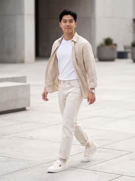 York – Light-wash straight-leg jeans, a tucked-in white organic cotton t-shirt, and an unbuttoned tan linen shirt for a clean, tonal summer aesthetic.