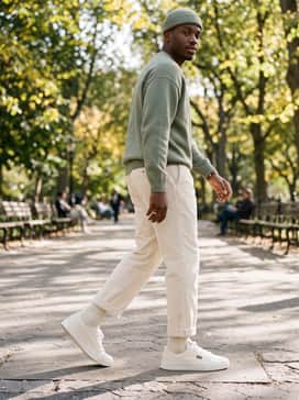 York – Cream-colored corduroy pants with an oversized sage green sweater and a matching beanie for a cozy, textural autumnal outfit.