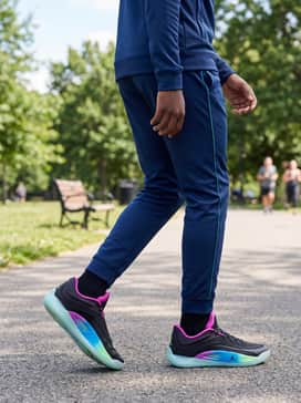 A coordinated navy blue athletic tracksuit with teal side-striping to complement the cool tones in the shoe's midsole.