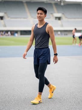 A team-branded compression racing singlet in deep purple paired with matching aerodynamic split shorts for a unified competition look.