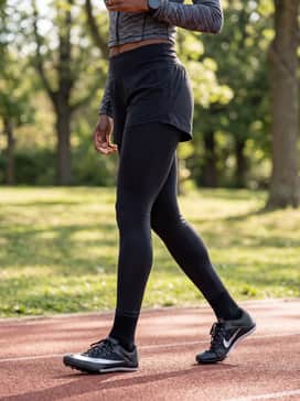 High-waisted compression leggings combined with a racerback sports bra and a cropped technical zip-up top for training sessions.