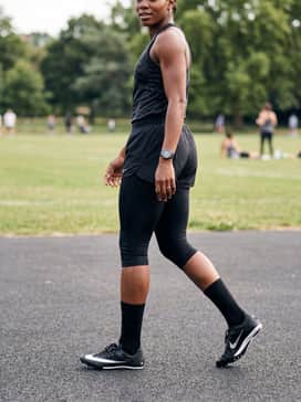 A team-branded athletic jersey tucked into matching technical shorts with calf-length compression socks for a coordinated professional look.