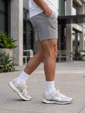 Heather grey biker shorts paired with a cream-colored oversized graphic sweatshirt and tall white crew socks to lean into the retro-athletic vibe.