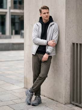 Zoom Vomero Roam – Olive drab joggers, a black moisture-wicking hoodie, and a silver-toned windbreaker to lean into the gorpcore aesthetic.